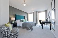 Grey bedroom in help to buy apartments at Parklands, Barking Riverside