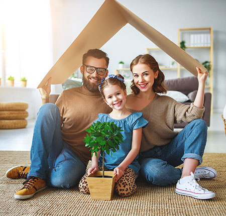 Family under cardboard home 