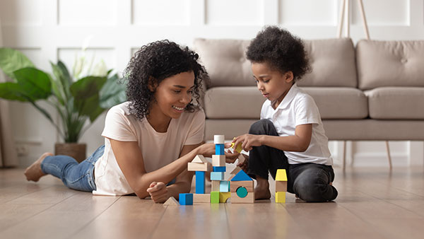 mum and child building home from bricks