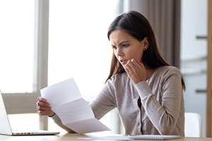 Young woman looking at declined mortgage application