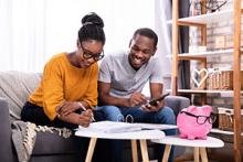 Young couple reading tips and tricks for saving for a new home